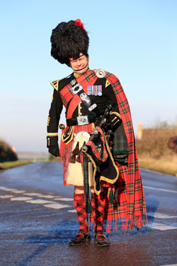 Roy playing the bagpipes at an event