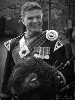 Roy playing the bagpipes at an event